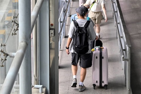 Tourist with trolley case