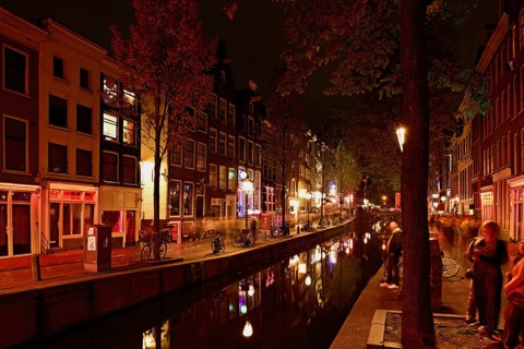 Night shot of the Oudezijds Achterburgwal in the red light district in Amsterdam, North Holland,