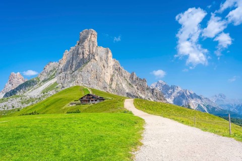 Scenic view of idyllic valley with hiking trail leading to refuge at the foot of majestic nuvolau