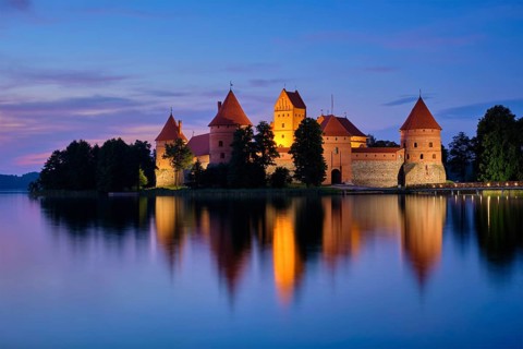 Night view of Trakai Island Castle in lake Galve illuminated in the evening, Lithuania, Europe