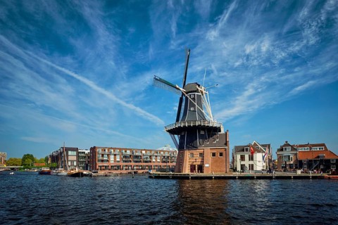 View of Harlem landmark windmill De Adriaan on Spaarne river. Harlem, Netherlands