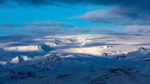 Light and shadow over the snowy hills and mountains of Myrdalsjökull, Sudurland, Iceland, Europe
