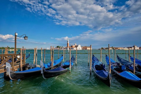 Gondolas and in lagoon of Venice by Saint Mark (San Marco) square with San Giorgio di Maggiore