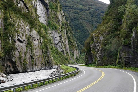 Road leads through a narrow canyon, high cliffs and Chugach Mountains, Thompson Pass, Richardson