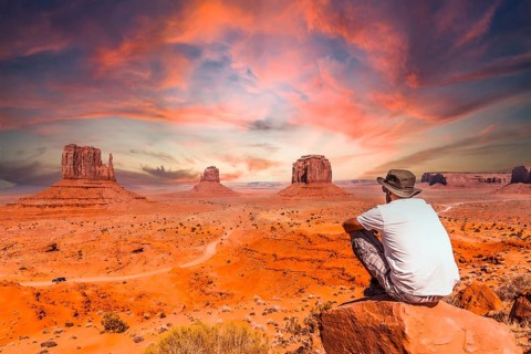 A young man in a white t-shirt in Monument Valley National Park at the visitor center at sunset,
