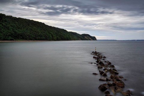 Coastal protection made of boulders, coastline on the Baltic Sea, dusk, long exposure, Baltic Sea