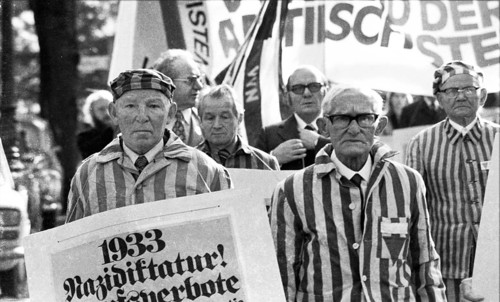 Nazi victims, some in concentration camp uniforms, demonstrated against the occupational bans