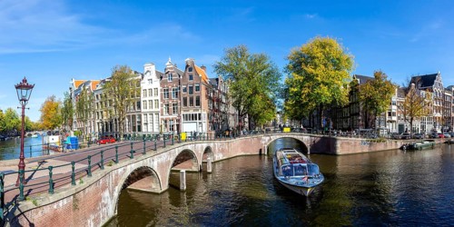 Canals and bridges building panorama at the Keizersgracht in the city of Amsterdam, Netherlands