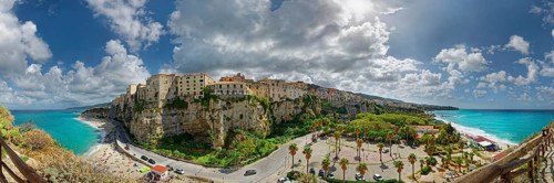 Panorama of the medieval old town of Tropea perched on rocks of sandstone with its turquoise sea