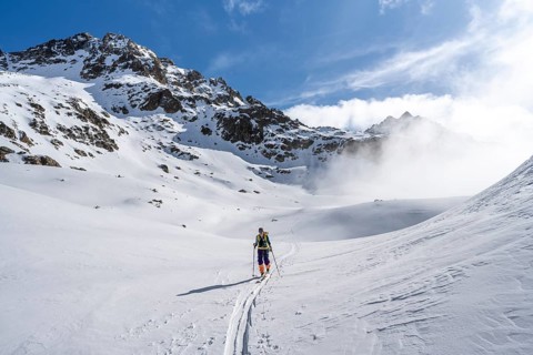 Ski tourers in a wintry mountain landscape, ascent to Porta d'Es-cha, Grisons Haute Route ski tour,