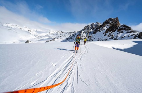 Ski tourer with rope, rope team on the Vadret da Porchabella glacier on the ascent to the summit of
