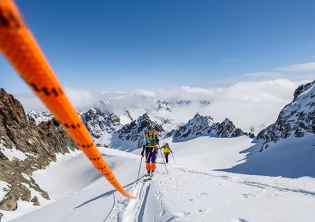 Ski tourer with rope, rope team on the Vadret da Porchabella glacier on the ascent to the summit of