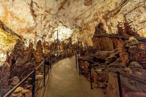 Footpath winding through stunning stalagmite and stalactite formations inside the famous postojna