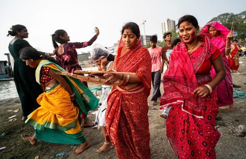 People arrives to offer prayers on the bank of Brahmaputra river on Ashoka Ashtami Festival during