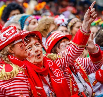 Colourfully costumed carnivalists celebrate carnival in Cologne, on Weiberfastnacht the street