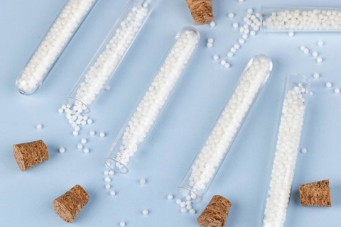 Test tubes with dropped globules and corks on a blue background