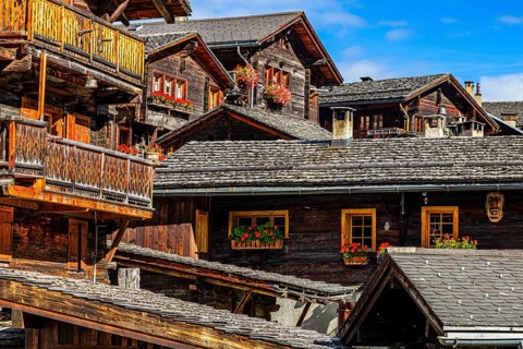 Old wooden houses decorated with flowers in the historic village centre, Grimentz, Val d'Anniviers,