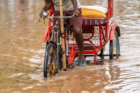 Commuters wade through a flooded street after heavy rains in Guwahati, India on April 28, 2025