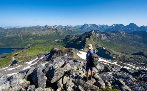 View of mountains and fjord landscape, mountain panorama, mountaineer at the summit of Rundfjellet,