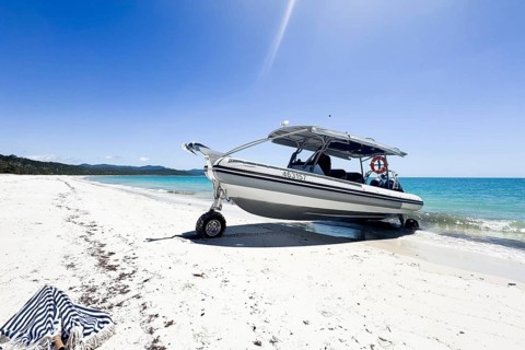 Boat on wheels standing at unique famous Whitehaven Beach. Modern amphibious boat capable to drive