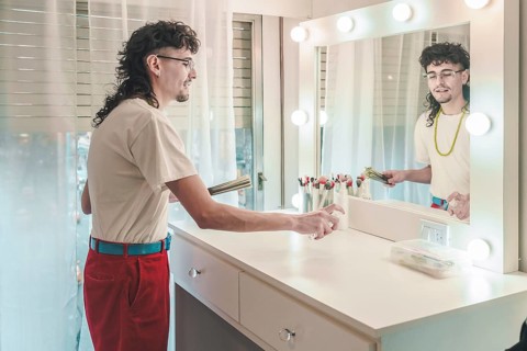 Makeup artist disinfecting and sanitizing workstation with spray bottle in beauty salon, getting