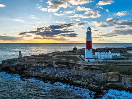 Sunset over Portland Bill Lighthouse from a drone, Portland Bill, Isle of Portland, Dorset,