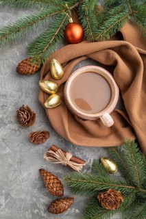 Christmas or New Year composition. Decorations, cones, cinnamon, fir and spruce branches, cup of