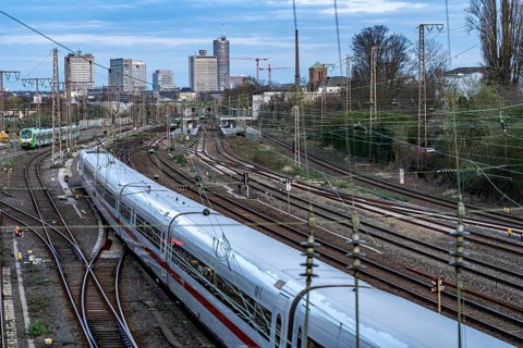 Train on the tracks west of Essen central station, skyline of the city centre, ICE train, North
