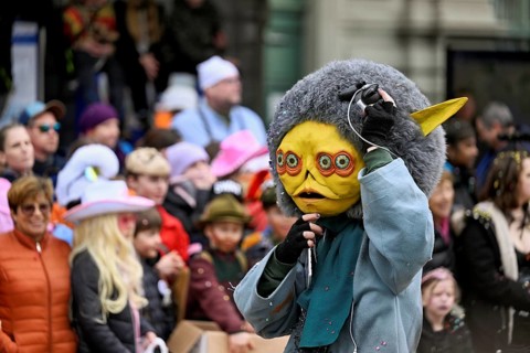 Person masked as an extraterrestrial at the carnival parade of the Wey guild on Rose Monday,
