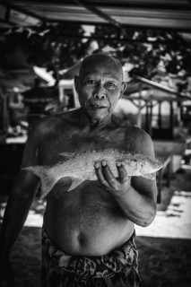Indonesian fishmonger at a market, fish, man, food, foodstuff, local, travel, long distance,