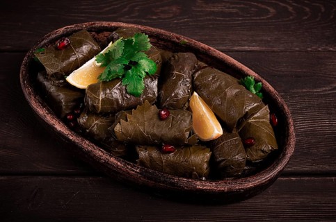 Dolma (Tolma) stuffed rolls, minced meat with rice, in grape leaves, top view, no people, close-up