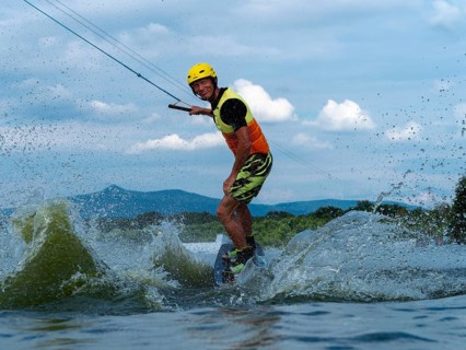 Man jumping with wakeboard, water sports, water skiing and wakepark