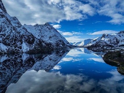 Aerial view of fjord, steep mountains, coast, winter, sun, Austvagoya, Lofoten, Norway, Europe