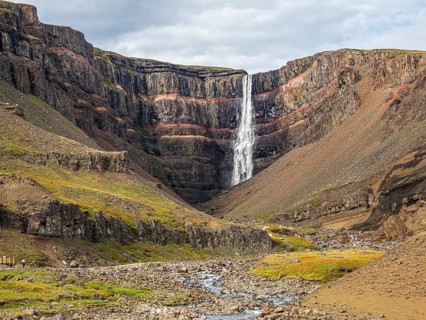 Waterfall Hengifoss, basaltic layers interwoven with red sedimentary layers, Iceland, Europe