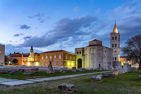 The Church of St Donatus, remains of the Roman forum and the bell tower of Zadar Cathedral at dusk,