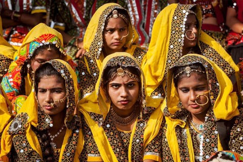 PUSHKAR, INDIA, NOVEMBER 21, 2012: Unidentified Rajasthani girls in traditional outfits prepare for