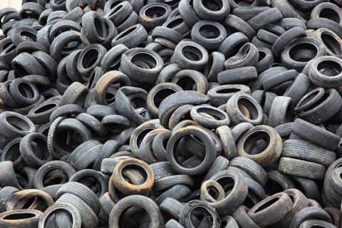 Old car tyres lie on stockpiles for recycling