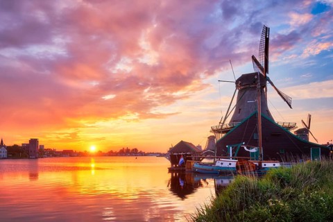 Netherlands rural scene, - windmills at famous tourist site Zaanse Schans in Holland on sunset with