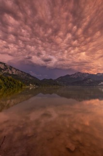 Stormy atmosphere, mountains reflected in lake, Lake Kochel, Alpine foothills, Bavaria, Germany,