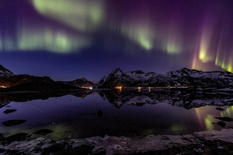 Northern lights over fjord, steep mountains, winter, aurora borealis, Flakstadoya, Lofoten, Norway,
