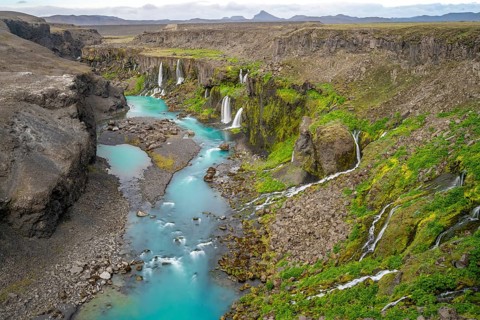 Waterfalls and a turquoise blue river flowing through a canyon, Sigöldugljúfur, long exposure,