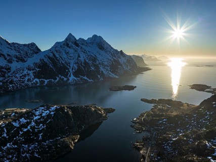 Aerial view of fjord and steep mountains, coast, winter, evening light, sun rays, Vestvagoya,