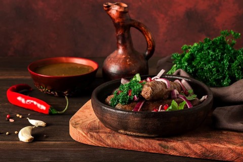 Georgian dish, fried Kupaty sausages, Ketsi on a traditional clay pan, horizontal, no people,