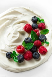 Breakfast, yogurt with fresh berries, raspberries and blueberries, on a white background, selective