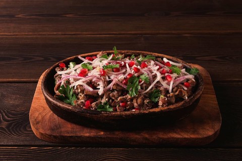 Kuchmachi, a traditional Georgian dish, in a clay Ketsi plate, close-up
