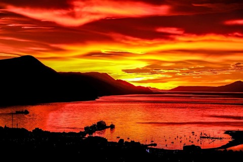 Ushuaia, Tierra del Fuego, Argentina, Glowing red sunrise over the Beagle Channel, the Beagle