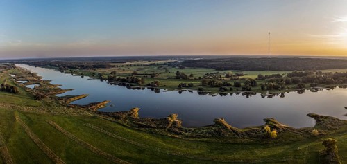 Panorama aerial view of river Elbe near Lenzen, view towards Höhbeck radio mast, calm summer