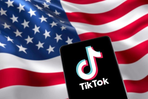 TikTok logo from China with USA United States of America flag social media on a mobile phone in