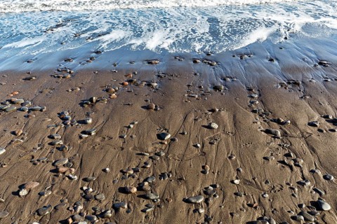 Pebbles on the black lava beach, seashore, Playa Quemada, Yaiza, Lanzarote, Spain, Europe