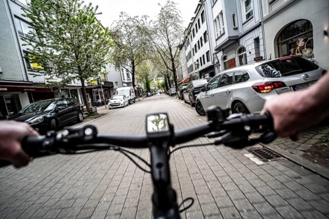Cycling in the city, inner-city street, cycle lane, bicycles have priority, two-lane traffic with